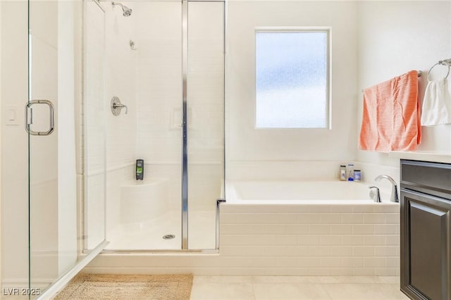 bathroom with tile patterned flooring, vanity, and shower with separate bathtub