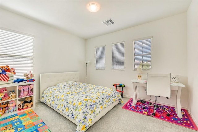 bedroom featuring light colored carpet