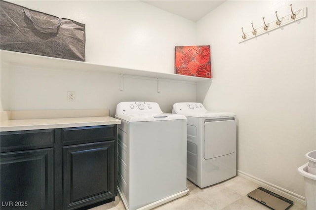 washroom featuring cabinets and independent washer and dryer