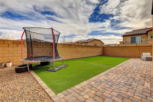 view of yard featuring a patio and a trampoline