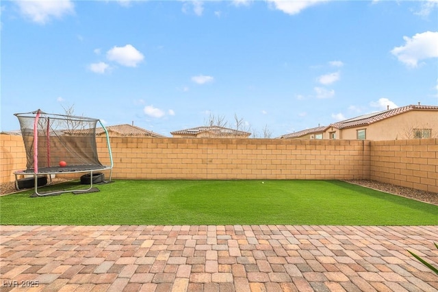 view of yard featuring a trampoline