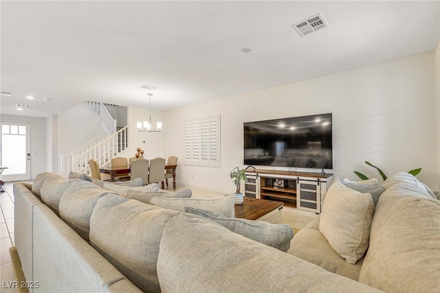 tiled living room featuring a chandelier