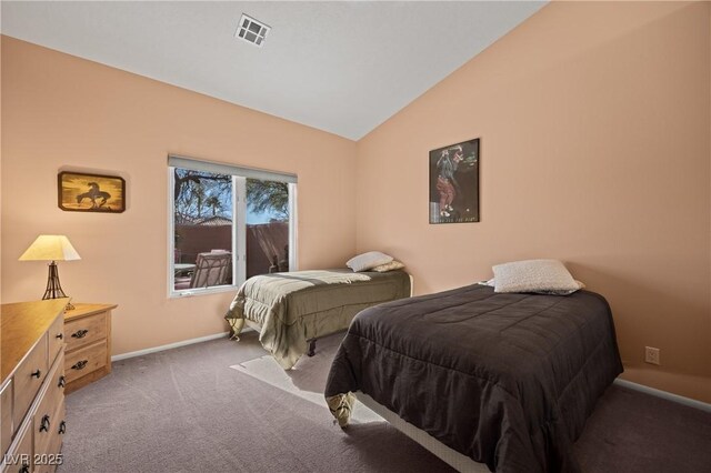 bedroom featuring dark colored carpet and vaulted ceiling