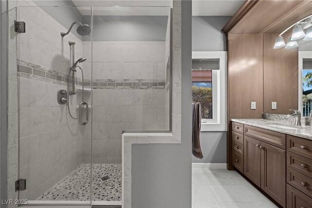 bathroom with walk in shower, vanity, and tile patterned flooring