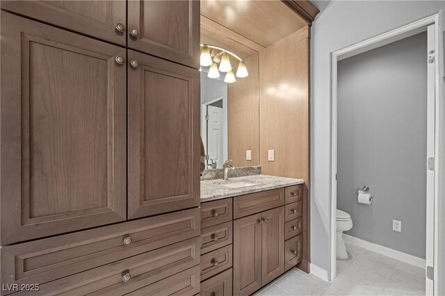 bathroom with vanity, tile patterned floors, and toilet