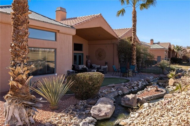 back of property with a patio and an outdoor hangout area