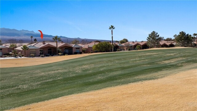 view of property's community featuring a mountain view and a lawn