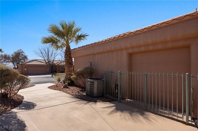 view of home's exterior featuring a garage and central air condition unit