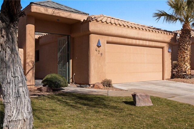 view of front facade with a garage and a front lawn