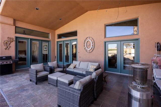 view of patio / terrace with an outdoor living space, a grill, and french doors