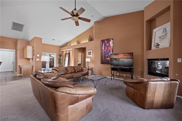 living room featuring ceiling fan, light colored carpet, and high vaulted ceiling