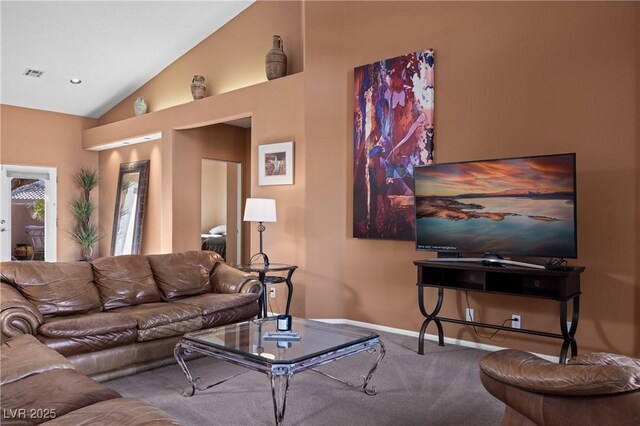 carpeted living room with vaulted ceiling