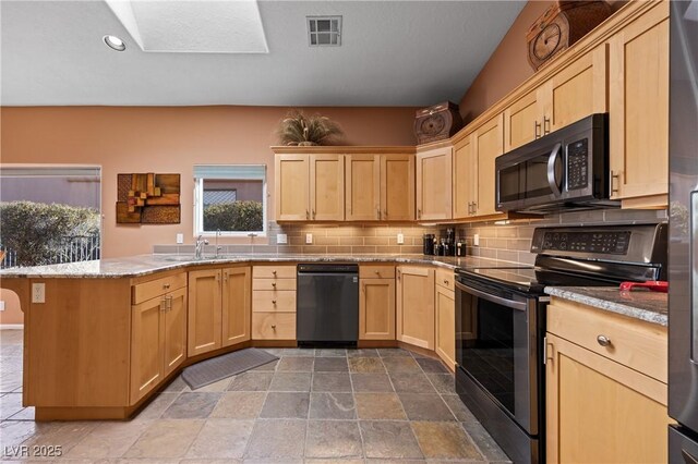 kitchen featuring appliances with stainless steel finishes, tasteful backsplash, light stone counters, kitchen peninsula, and light brown cabinets