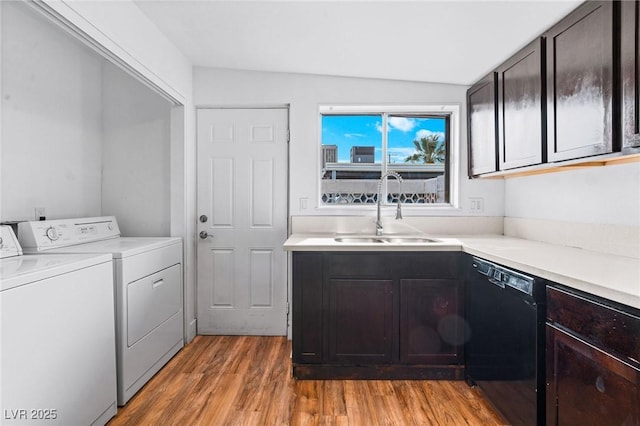 washroom featuring sink, hardwood / wood-style floors, and washer and clothes dryer