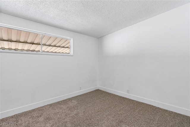 carpeted spare room featuring a textured ceiling