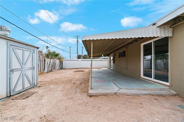 view of yard featuring a patio and a shed