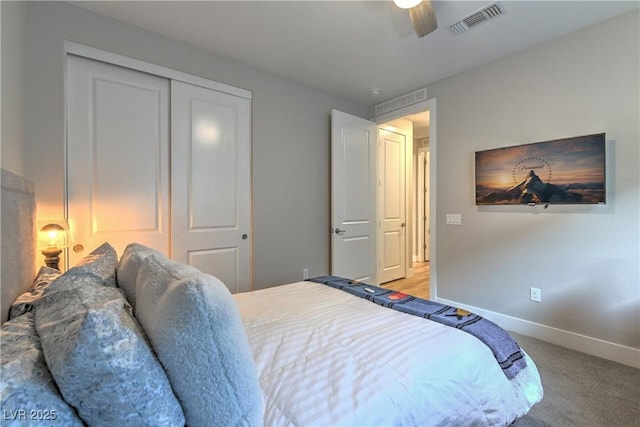 carpeted bedroom with ceiling fan and a closet