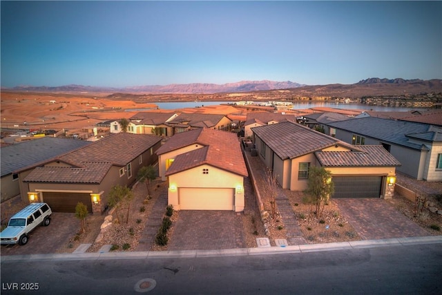 aerial view at dusk featuring a mountain view