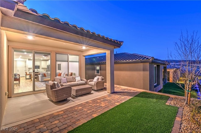 patio terrace at dusk with an outdoor living space