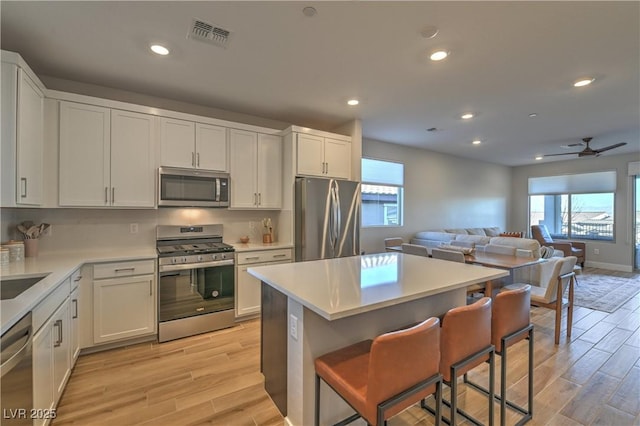 kitchen featuring white cabinets and appliances with stainless steel finishes