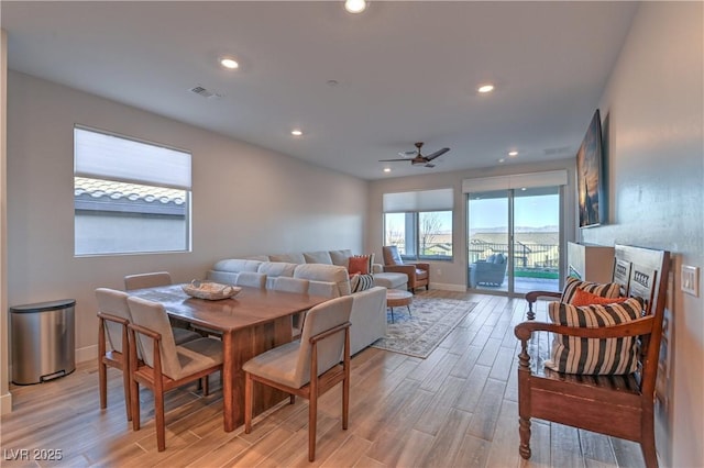 dining area with ceiling fan and light hardwood / wood-style flooring