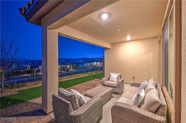 patio at night with a mountain view and outdoor lounge area