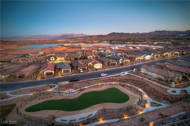 aerial view at dusk with a water and mountain view