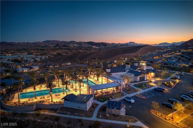 aerial view at dusk featuring a mountain view