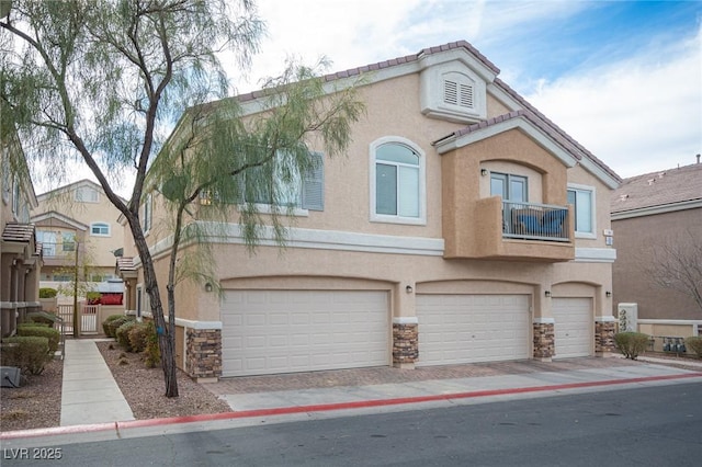 view of property with a garage and a balcony