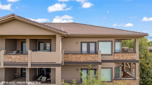 rear view of property with a balcony