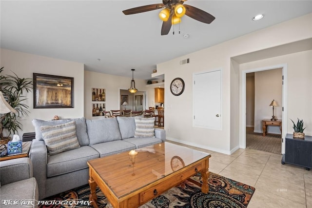 living room featuring light tile patterned floors and ceiling fan