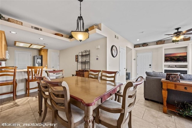 dining space featuring light tile patterned floors and ceiling fan