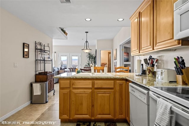 kitchen featuring sink, hanging light fixtures, kitchen peninsula, white appliances, and french doors