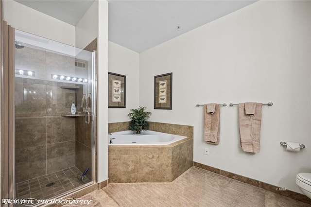 bathroom with tile patterned floors, toilet, and separate shower and tub