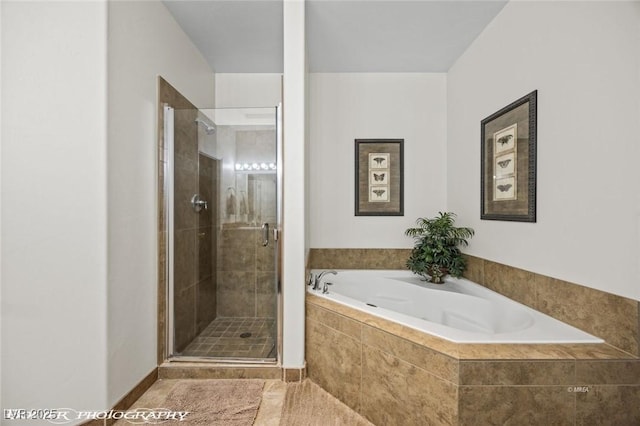 bathroom with tile patterned floors and shower with separate bathtub