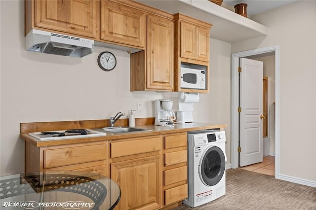 interior space with light carpet, sink, washer / dryer, and white appliances