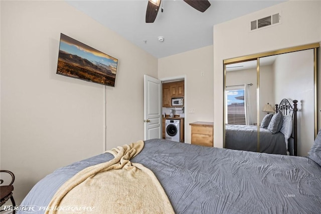 bedroom featuring ceiling fan, washer / dryer, and a closet