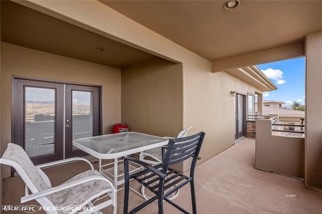 view of patio / terrace featuring french doors and a balcony