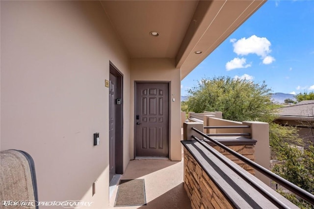 view of exterior entry with a balcony