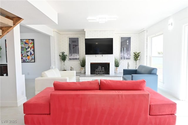 living room featuring a brick fireplace