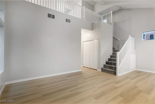 interior space with a high ceiling and light hardwood / wood-style floors