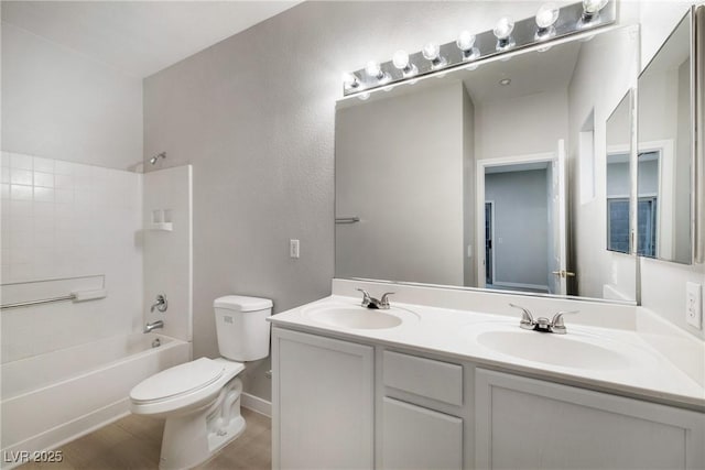 full bathroom with vanity, hardwood / wood-style flooring, toilet, and washtub / shower combination