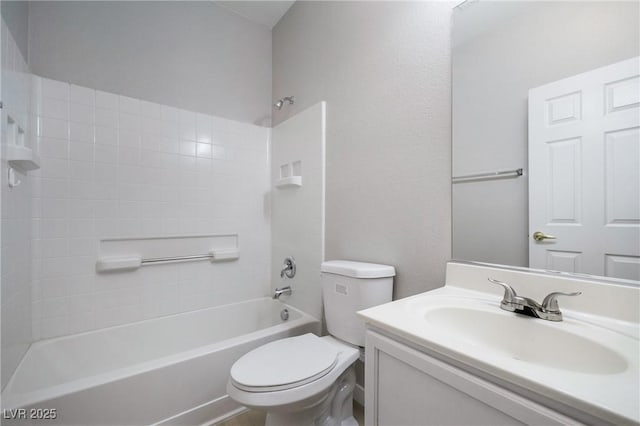 full bathroom with vanity, tiled shower / bath combo, and toilet