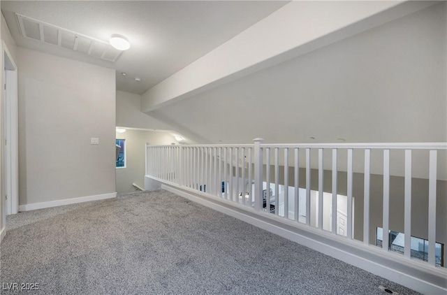 additional living space with beamed ceiling and carpet