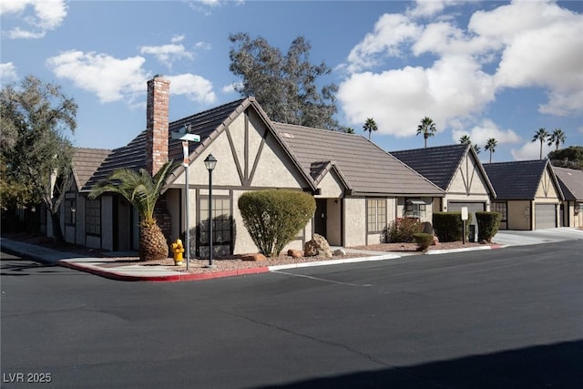 tudor house featuring a garage