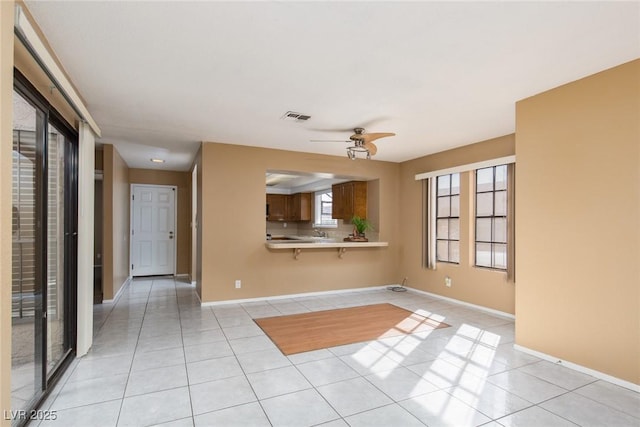 unfurnished room featuring light tile patterned floors and ceiling fan