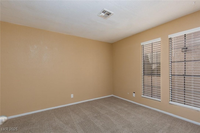 unfurnished room with a textured ceiling and carpet