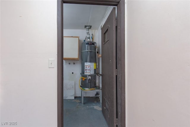 utility room featuring strapped water heater