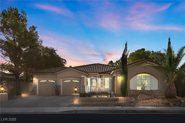 mediterranean / spanish home featuring a garage