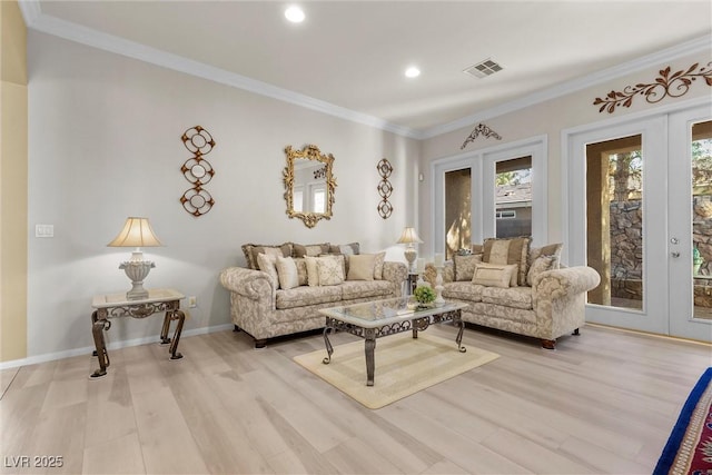 living room with french doors, ornamental molding, and light wood-type flooring